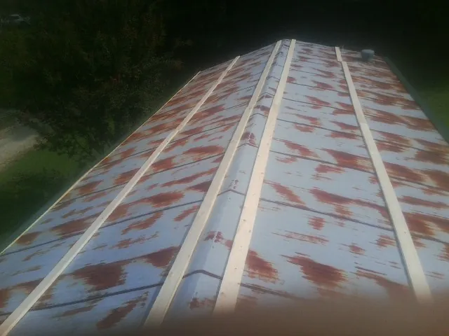 Rusted metal roof panels with new wood purlins before replacement — Storm Damage Roof Repair in Barhamsville by Roofing Brothers
