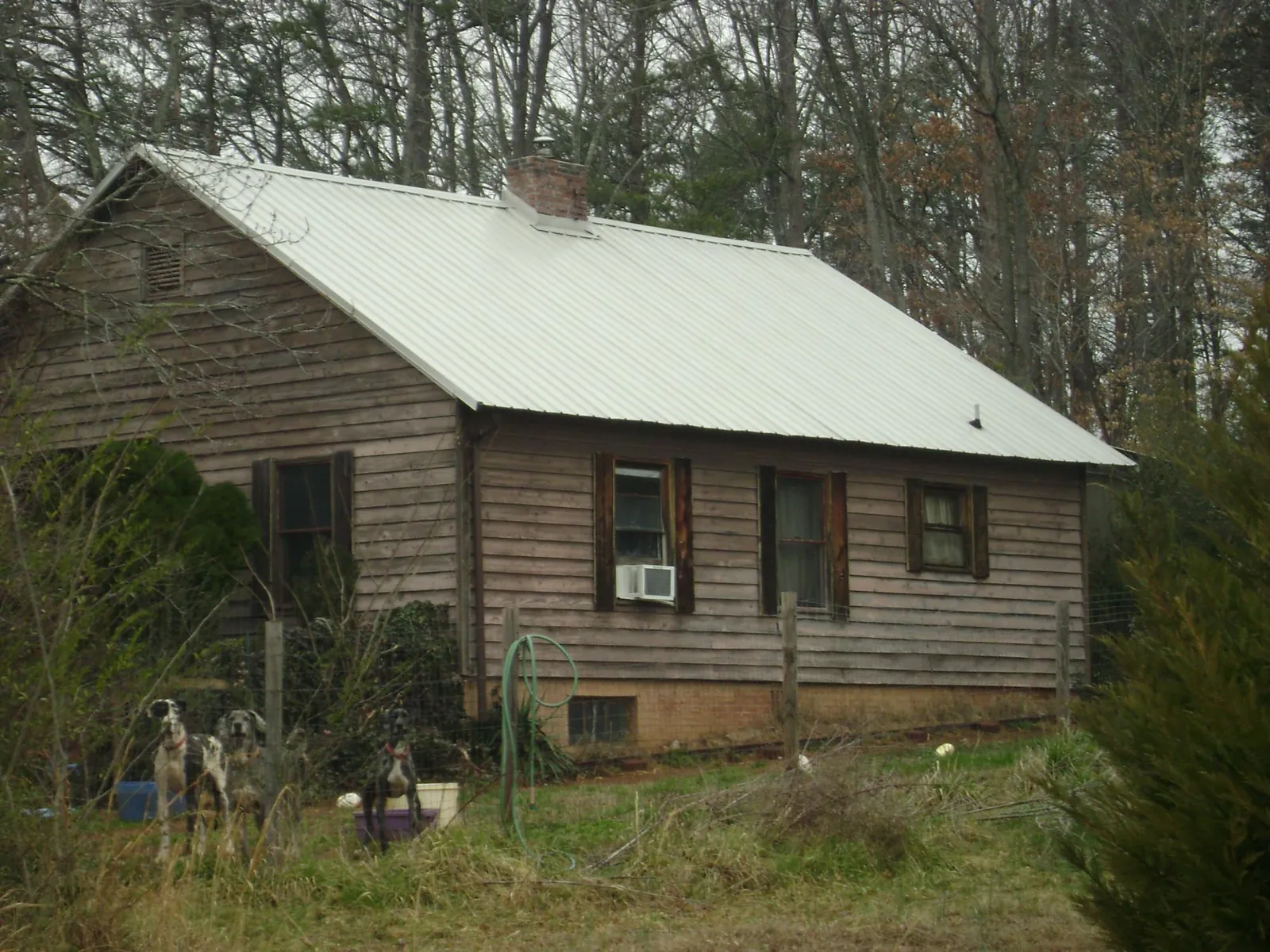 White metal roof on an old wood sided farmhouse, from a Metal Roof Installation job in Barhamsville